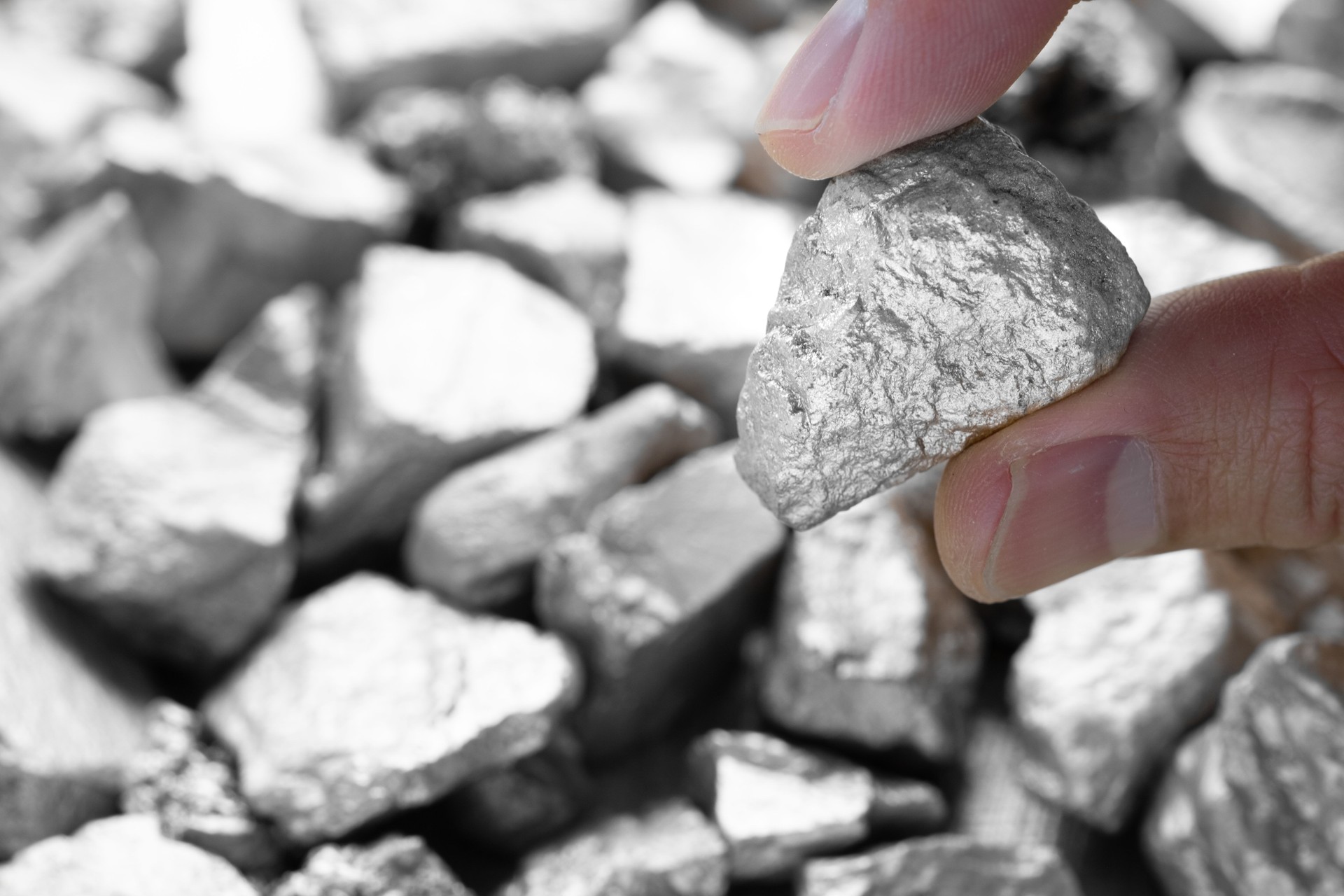 Miners hold in their hands platinum or silver or rare earth minerals found in the mine for inspection and consideration